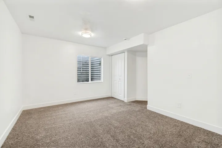 Unfurnished bedroom featuring carpet flooring and a closet