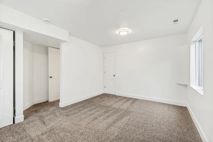 Unfurnished bedroom featuring carpet and baseboards