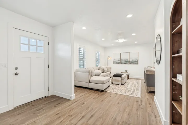 Entrance foyer with light wood-style flooring and recessed lighting