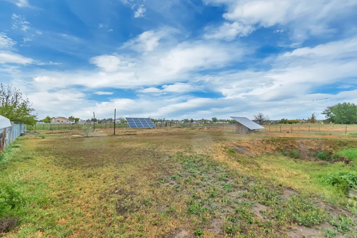 View of yard featuring a view of rural / pastoral area and an outdoor structure