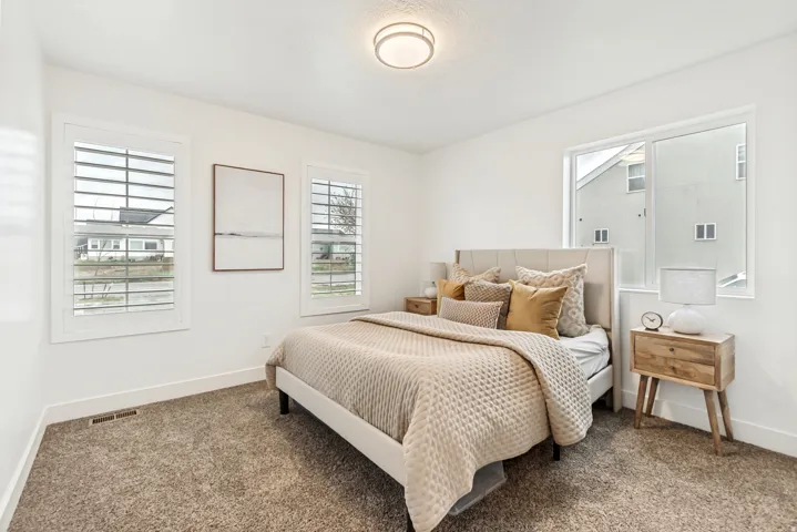 Carpeted bedroom with baseboards