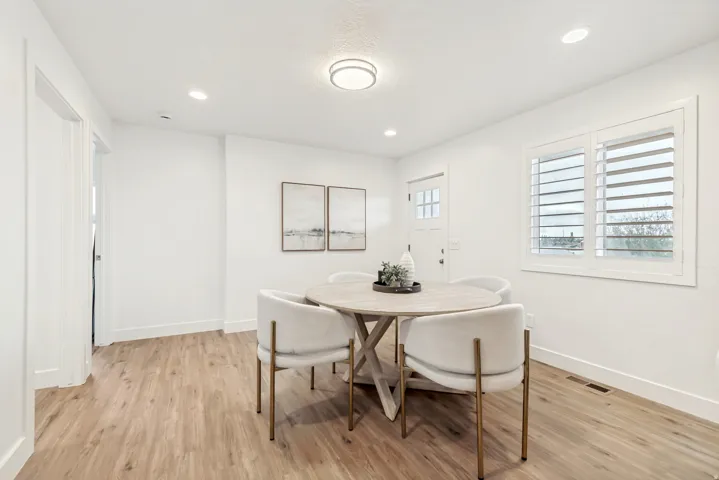 Dining space with light wood-style flooring and recessed lighting