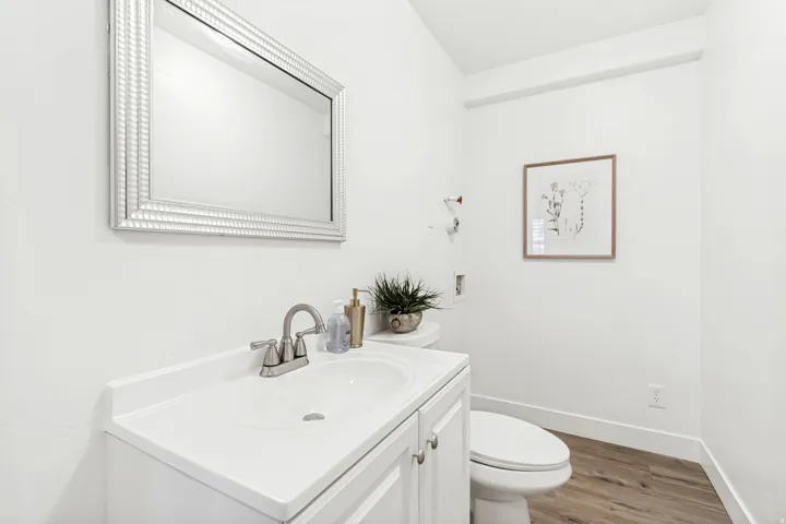 Half bathroom featuring vanity and light wood finished floors