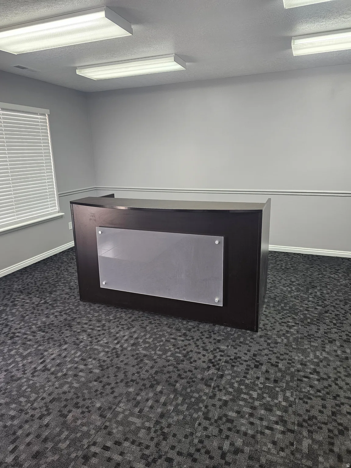 Detailed view of a textured ceiling and baseboards