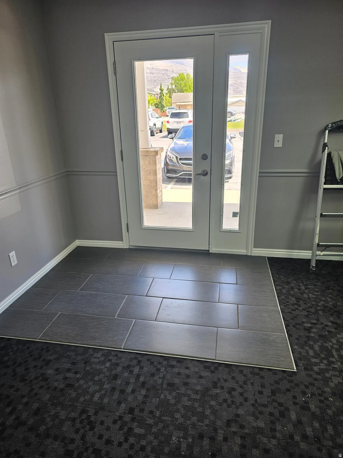 Entryway with french doors and tile patterned flooring