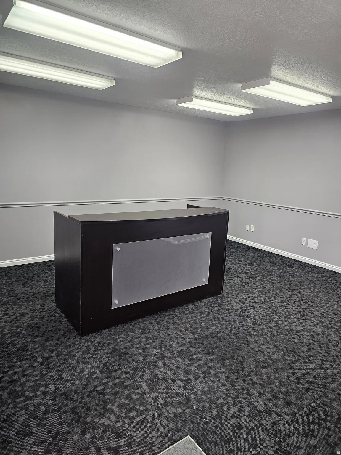 Unfurnished office featuring a textured ceiling