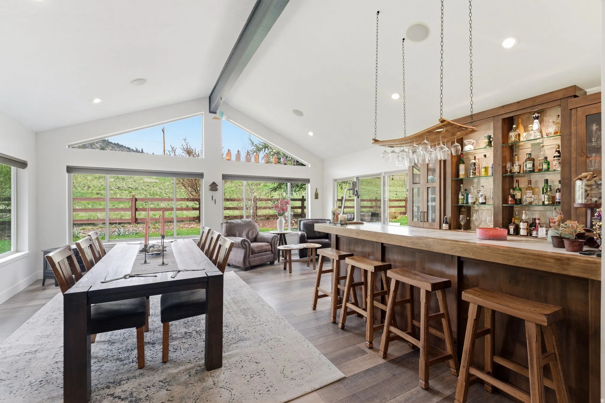 Dining space featuring recessed lighting, wood finished floors, and a bar