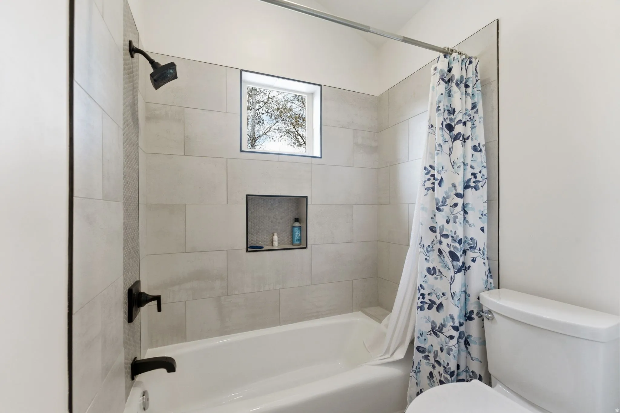 Full bathroom with toilet and shower / tub combo