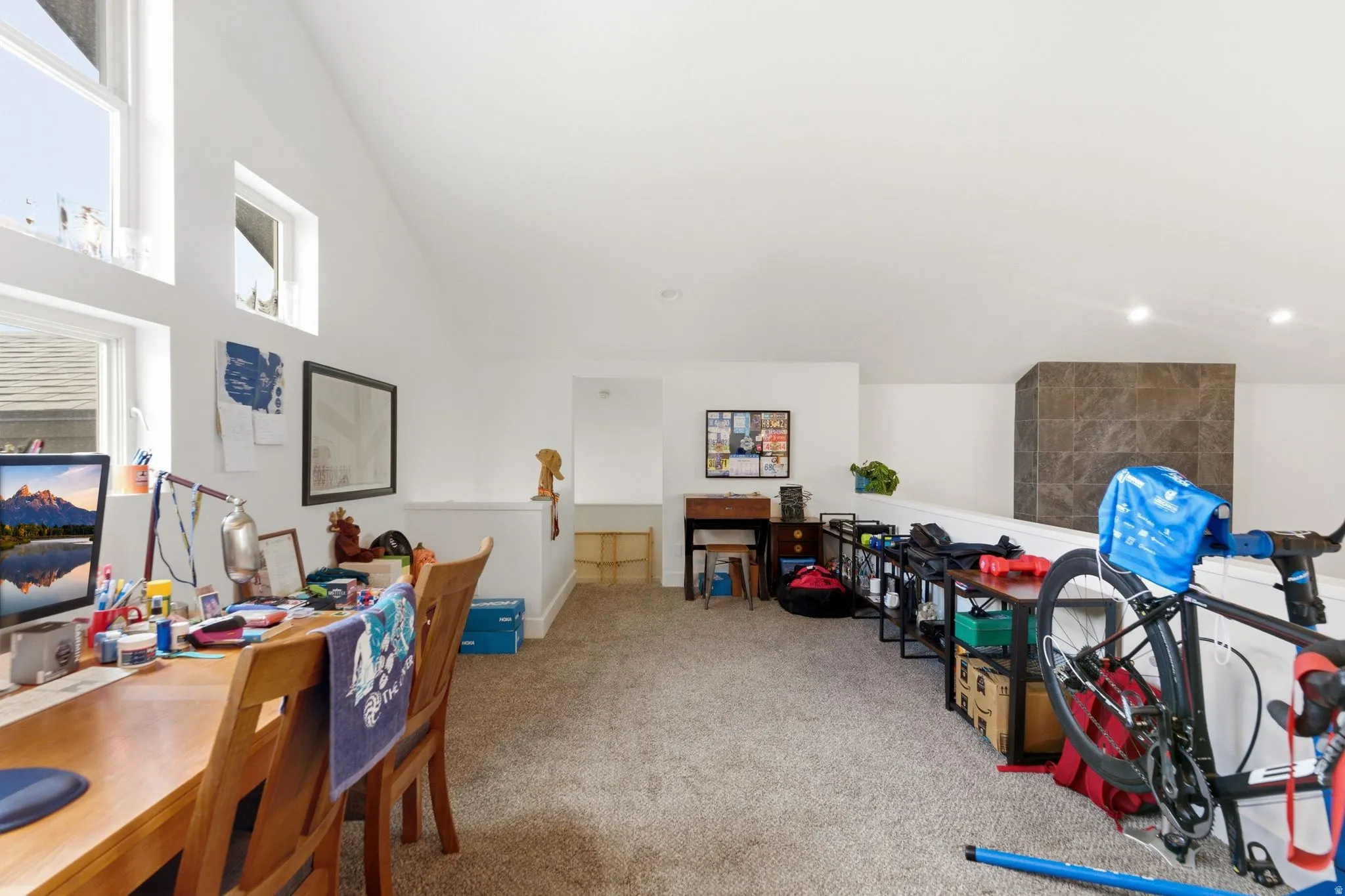 Game room with lofted ceiling and light colored carpet