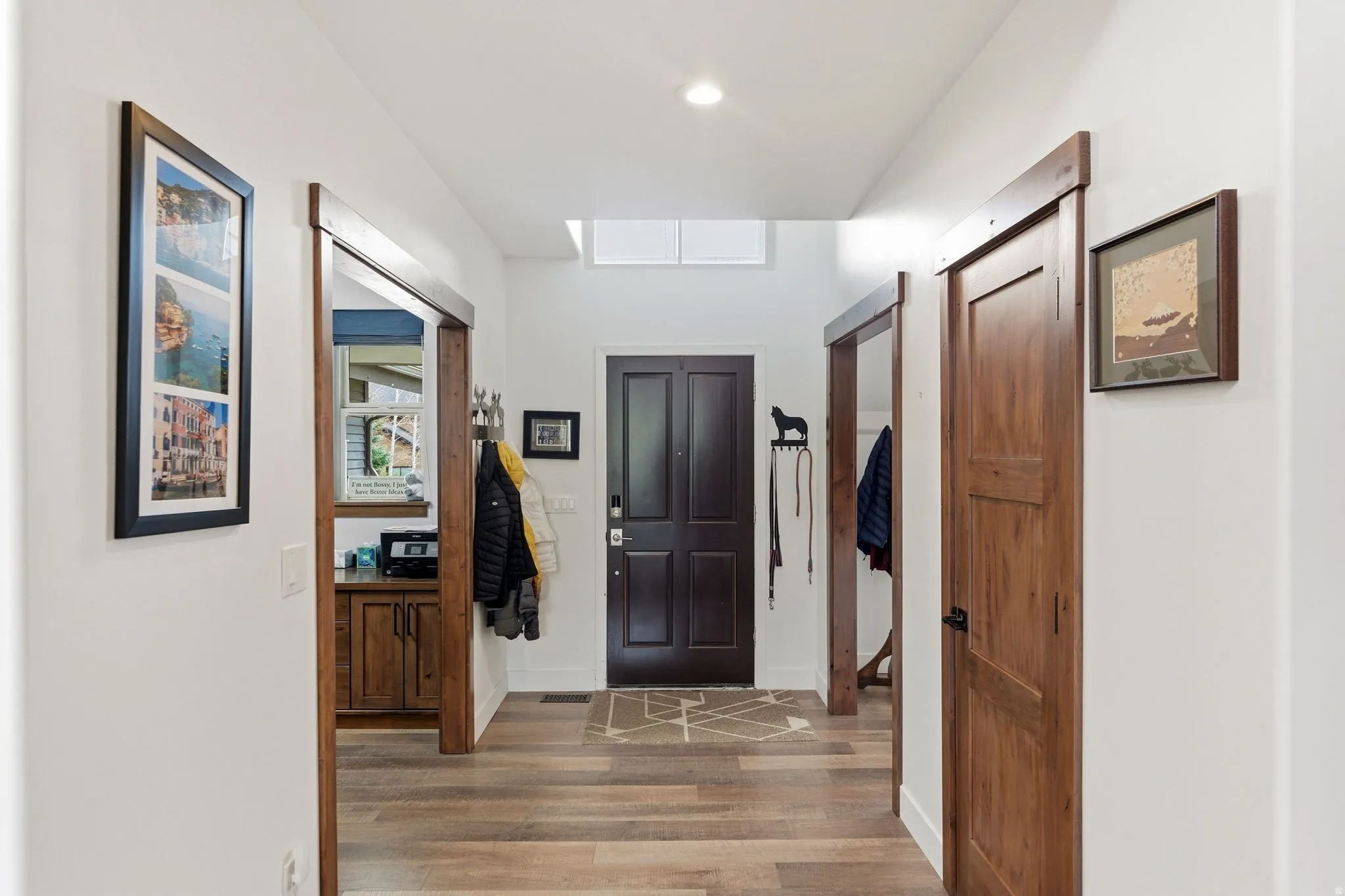 Entrance foyer with wood finished floors and baseboards