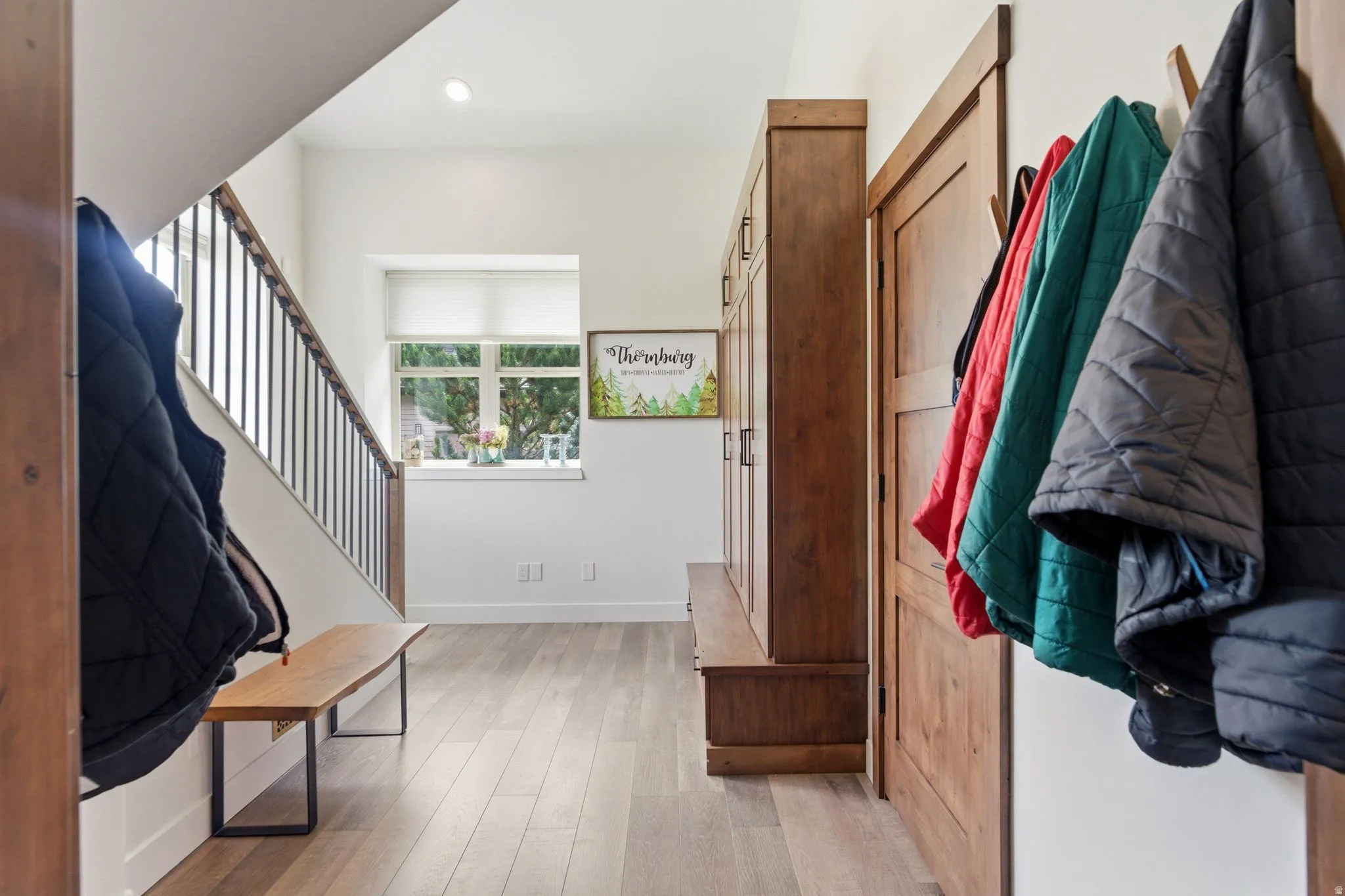 Mudroom featuring light wood finished floors and recessed lighting