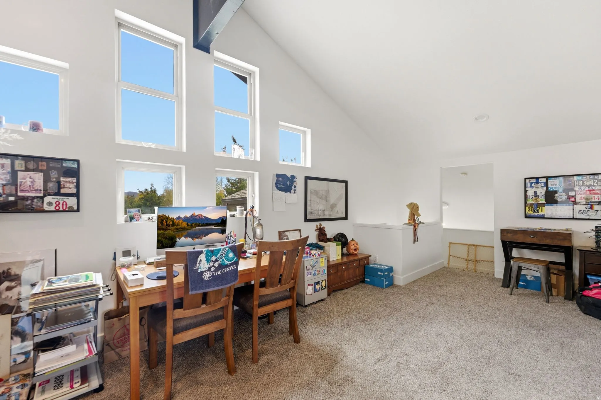 Office area with carpet floors and lofted ceiling