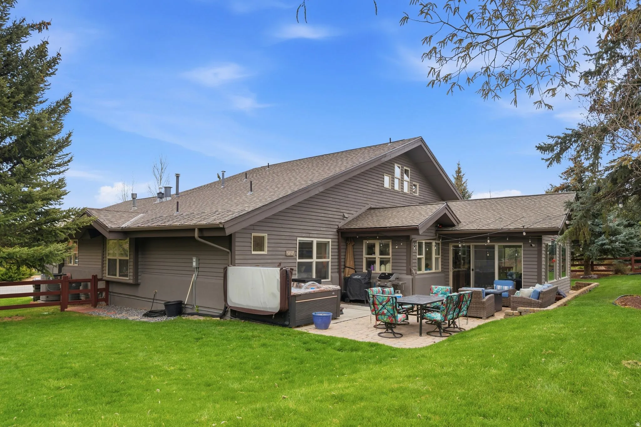 Rear view of house with roof with shingles, a patio area, and an outdoor lounge area