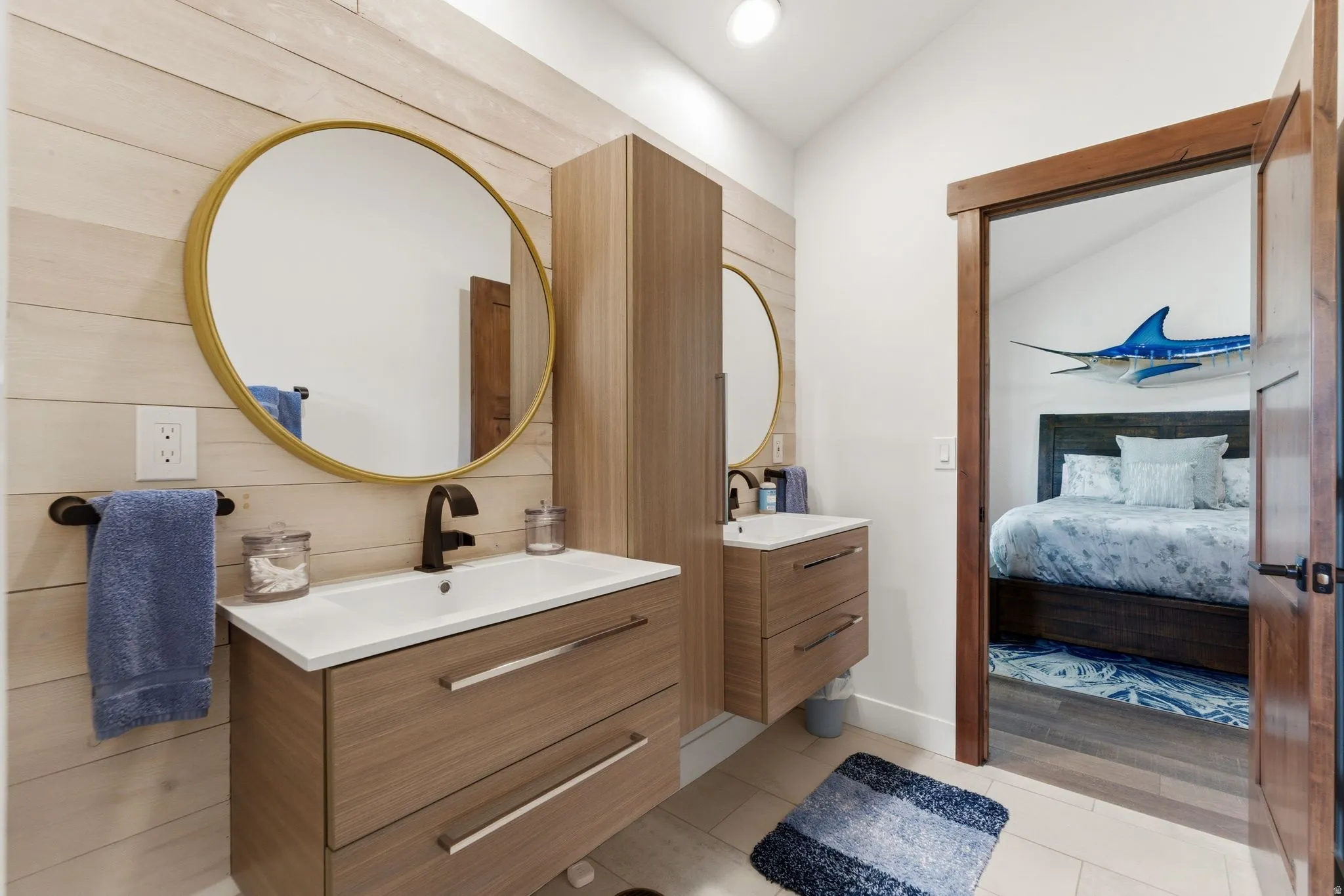 Full bathroom with two vanities, light tile patterned floors, lofted ceiling, ensuite bath, and recessed lighting