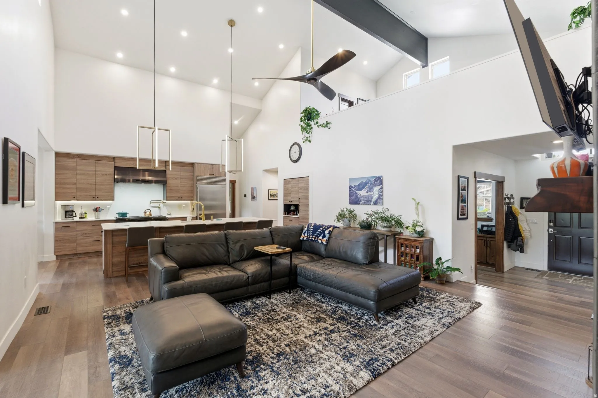 Living area featuring dark wood finished floors, recessed lighting, and vaulted ceiling