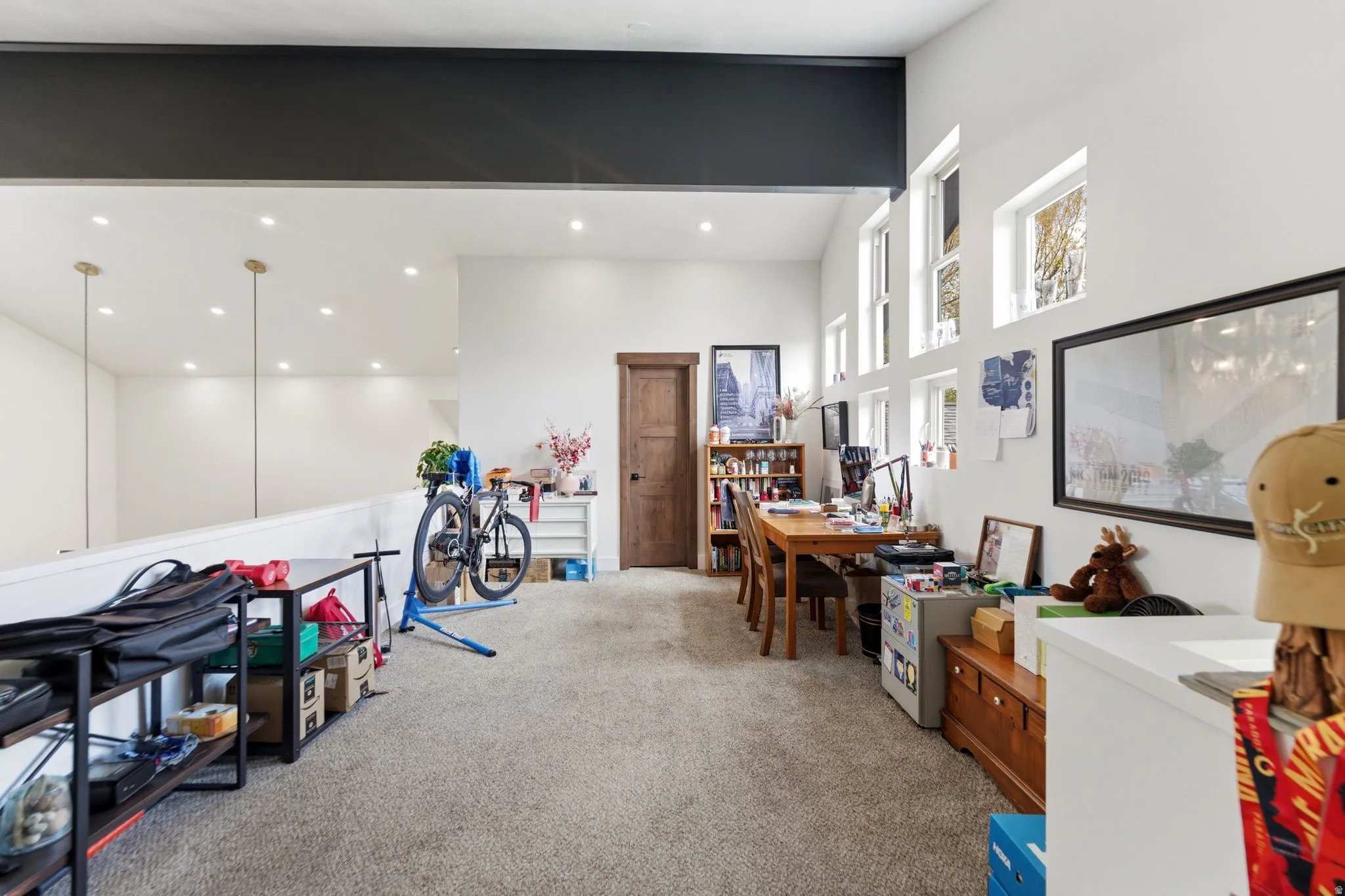 Office area with light carpet and a high ceiling