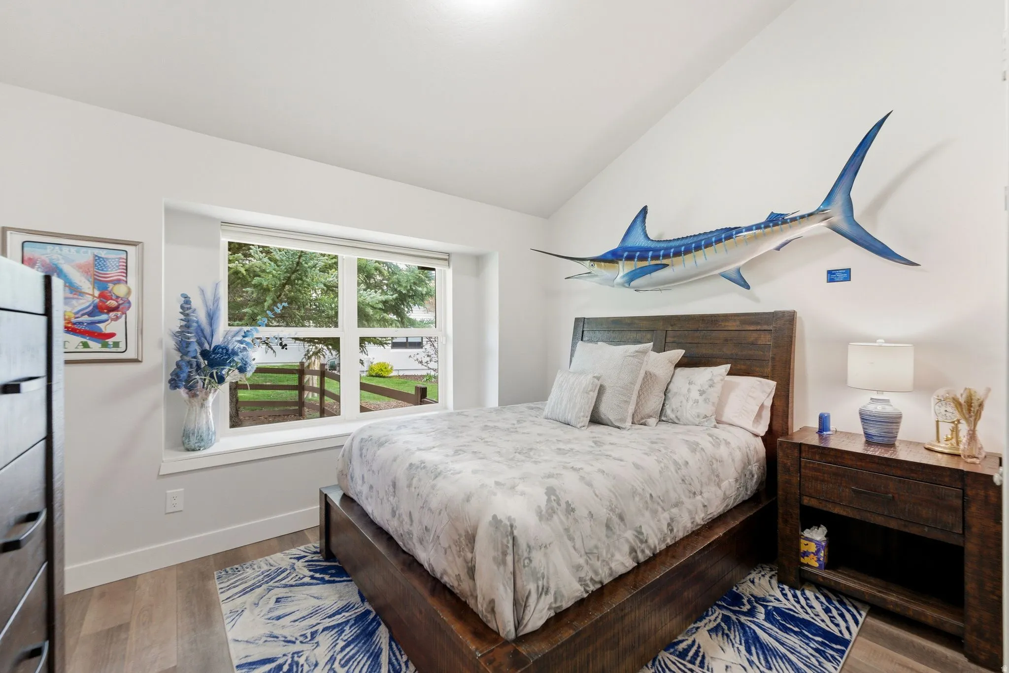 Bedroom featuring wood finished floors and lofted ceiling