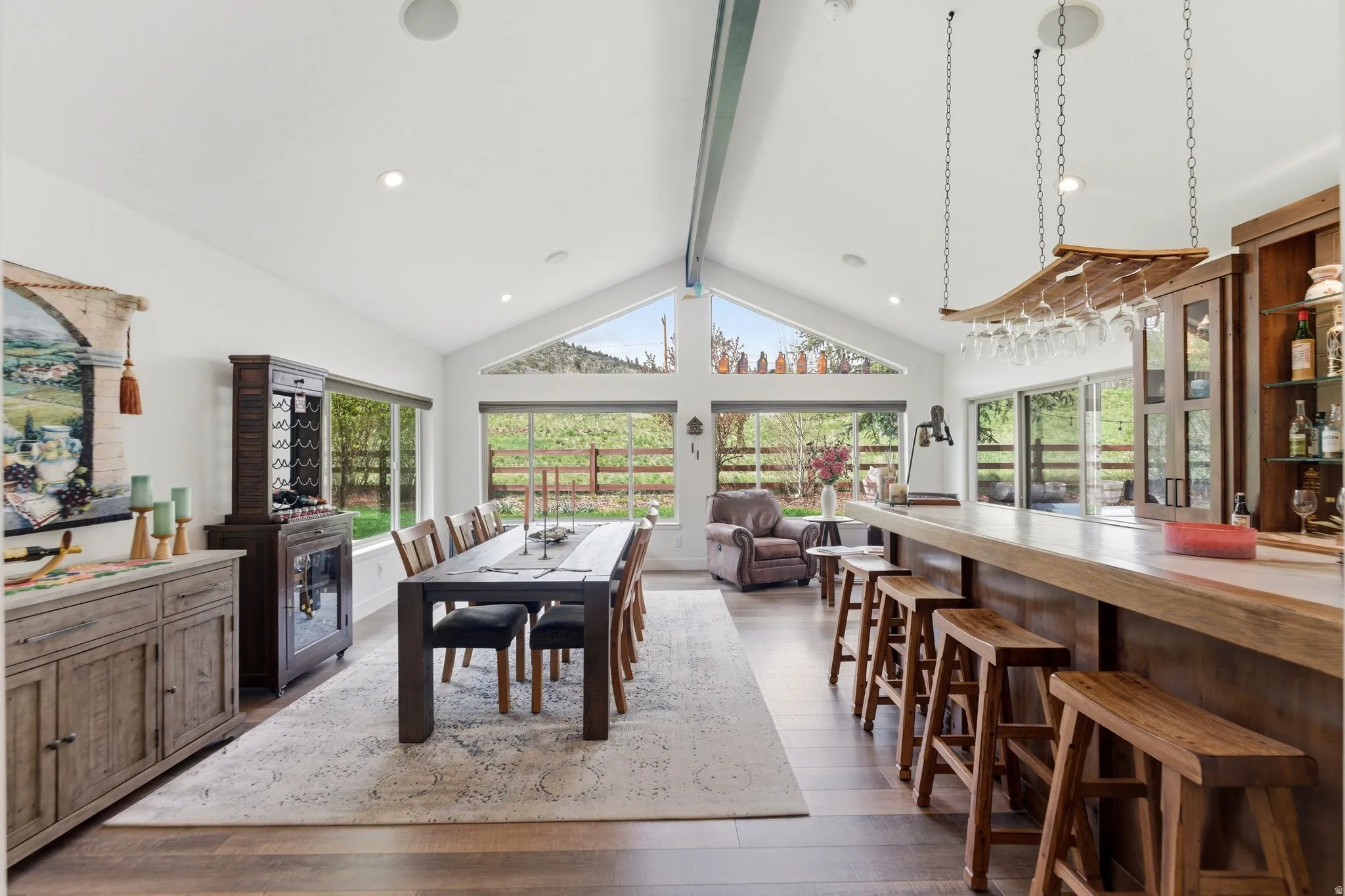 Dining space with dark wood-style floors and recessed lighting
