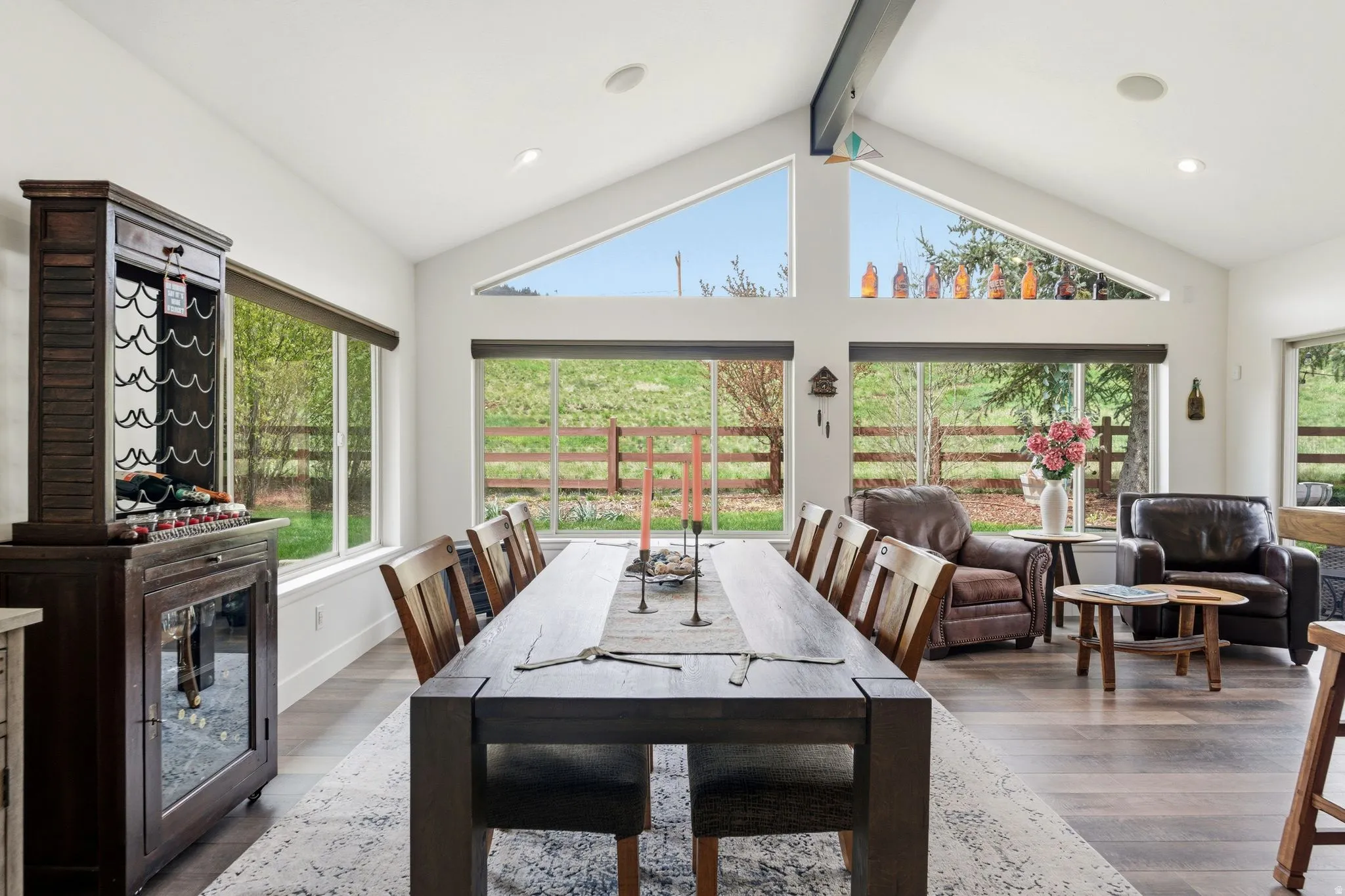 Dining room featuring wood finished floors, beamed ceiling, recessed lighting, and plenty of natural light