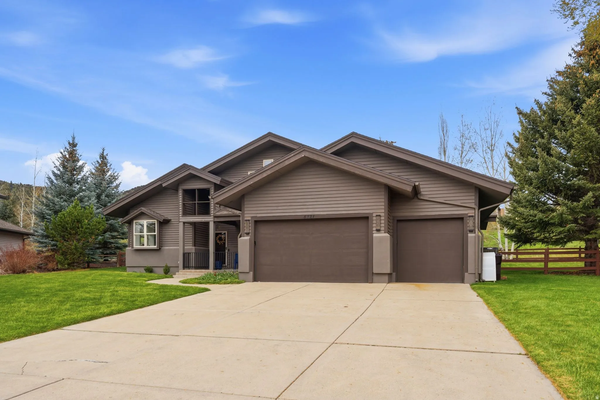 View of front facade featuring an attached garage and driveway