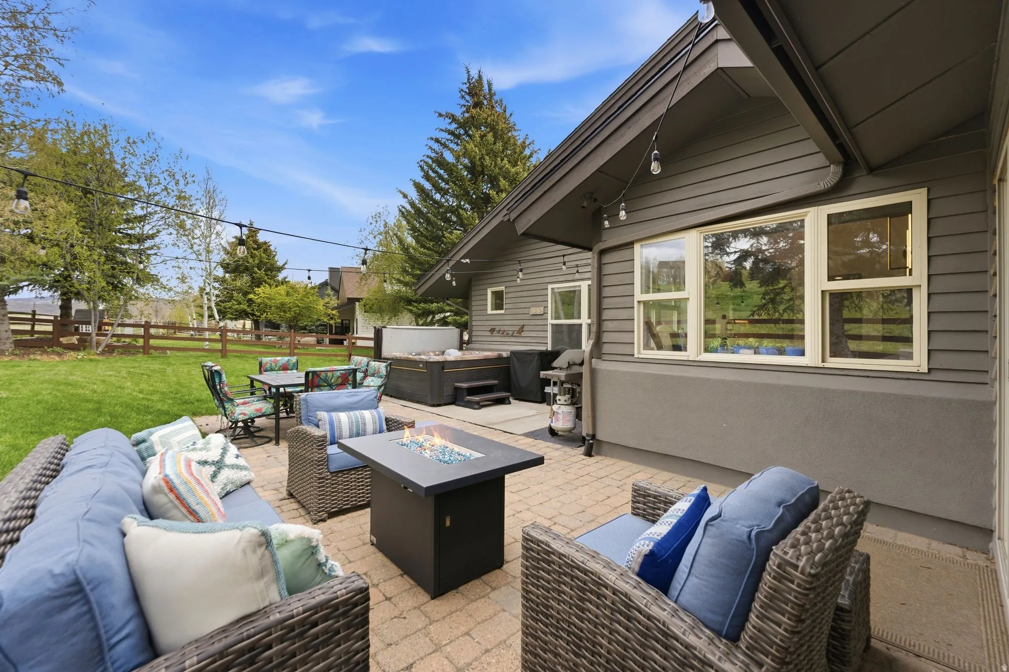 View of patio featuring a fire pit, outdoor lounge area, and grilling area