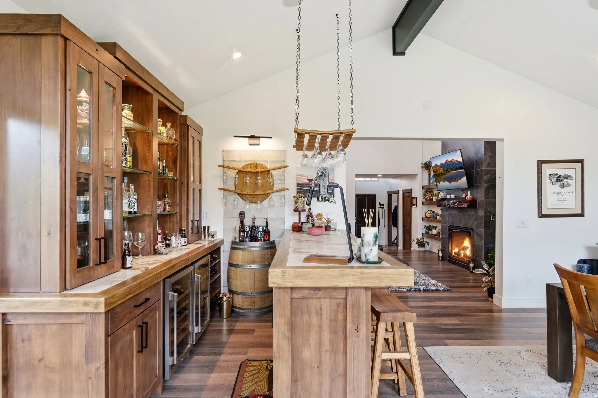 Kitchen featuring open shelves, a tiled fireplace, dark wood-type flooring, glass insert cabinets, and wood counters