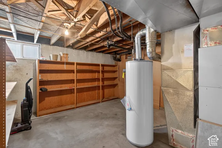 Below grade area with heating unit and water heater