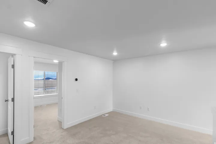 Basement featuring light colored carpet and recessed lighting