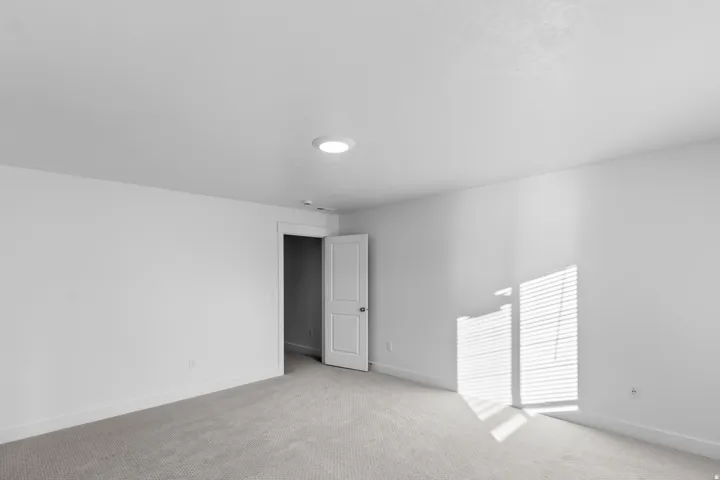 Carpeted empty room featuring baseboards