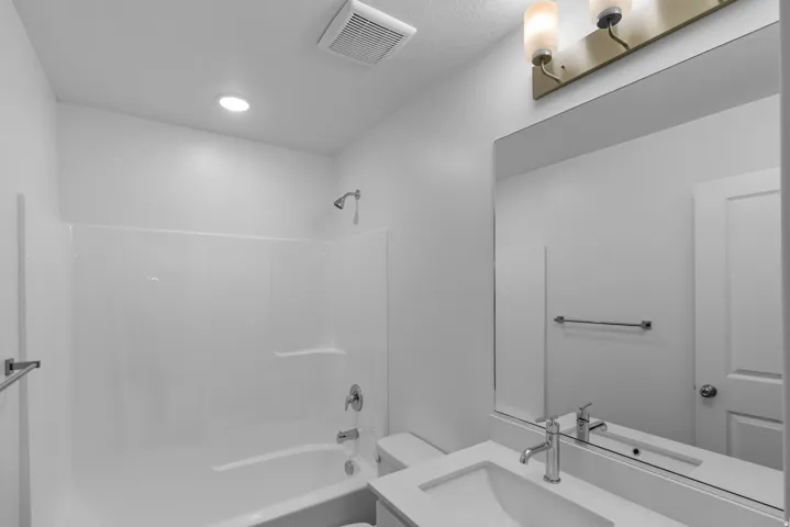 Bathroom featuring vanity and bathing tub / shower combination