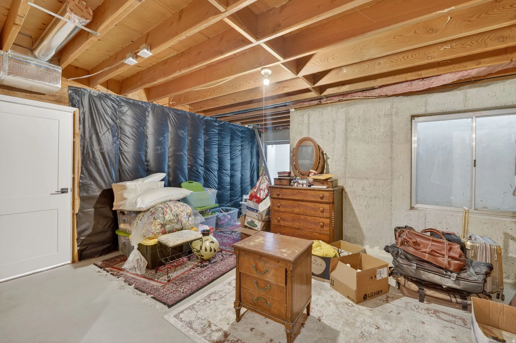 Sitting room featuring unfinished concrete floors