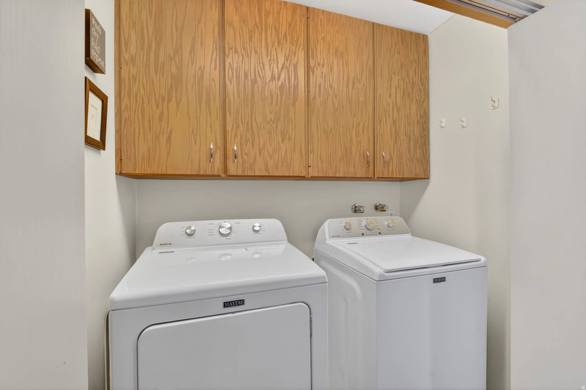 Laundry room with washer and dryer and cabinet space