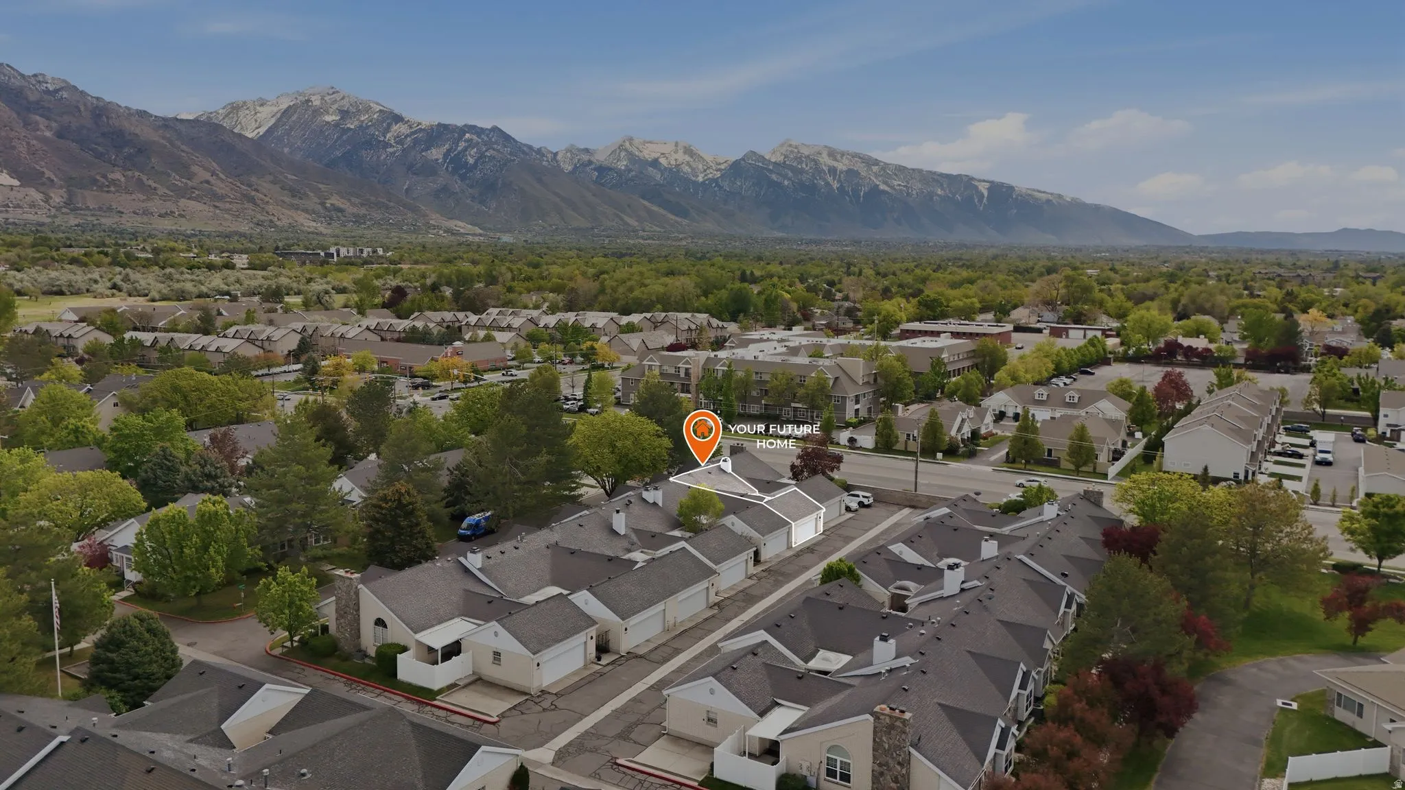 Aerial perspective of suburban area featuring a mountainous background