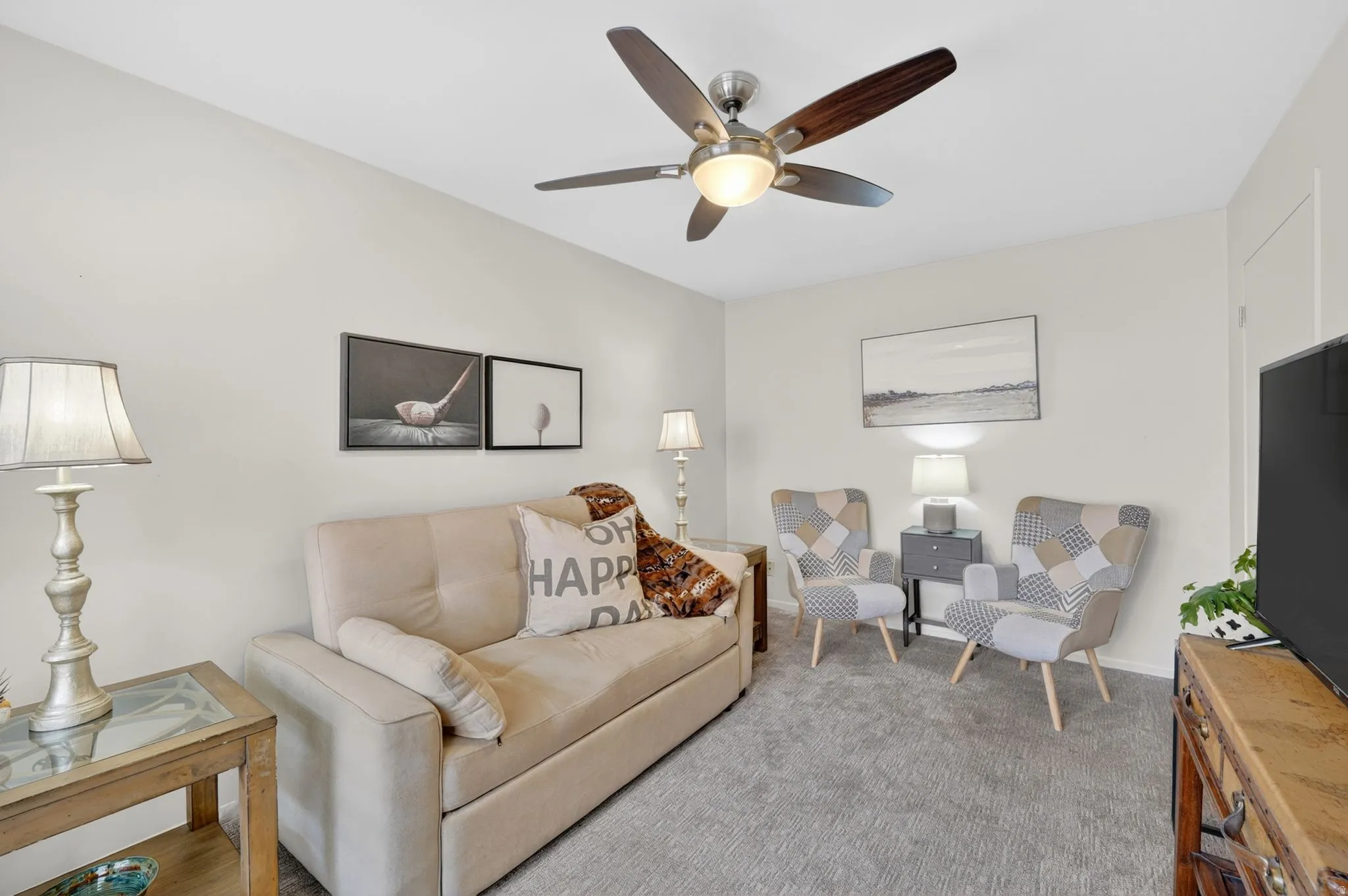 Living room featuring carpet flooring and ceiling fan