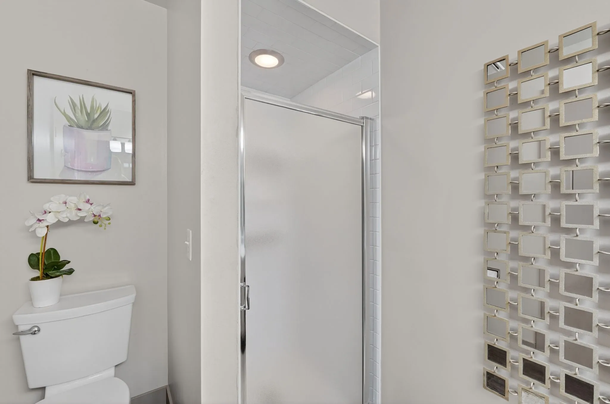Bathroom featuring a shower stall and toilet