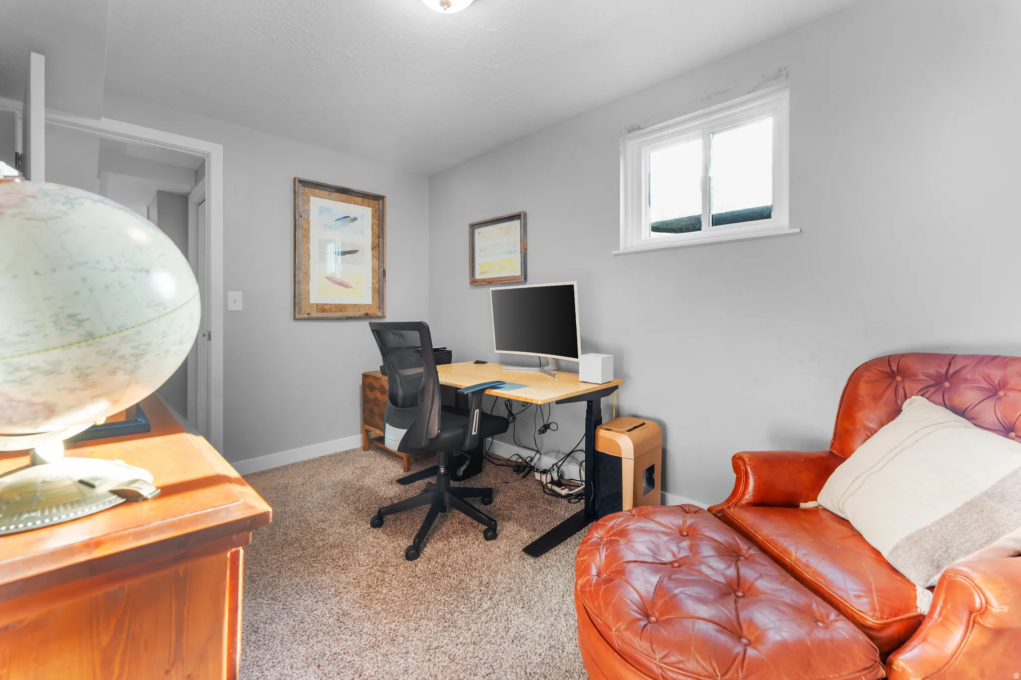 Office with light carpet and baseboards