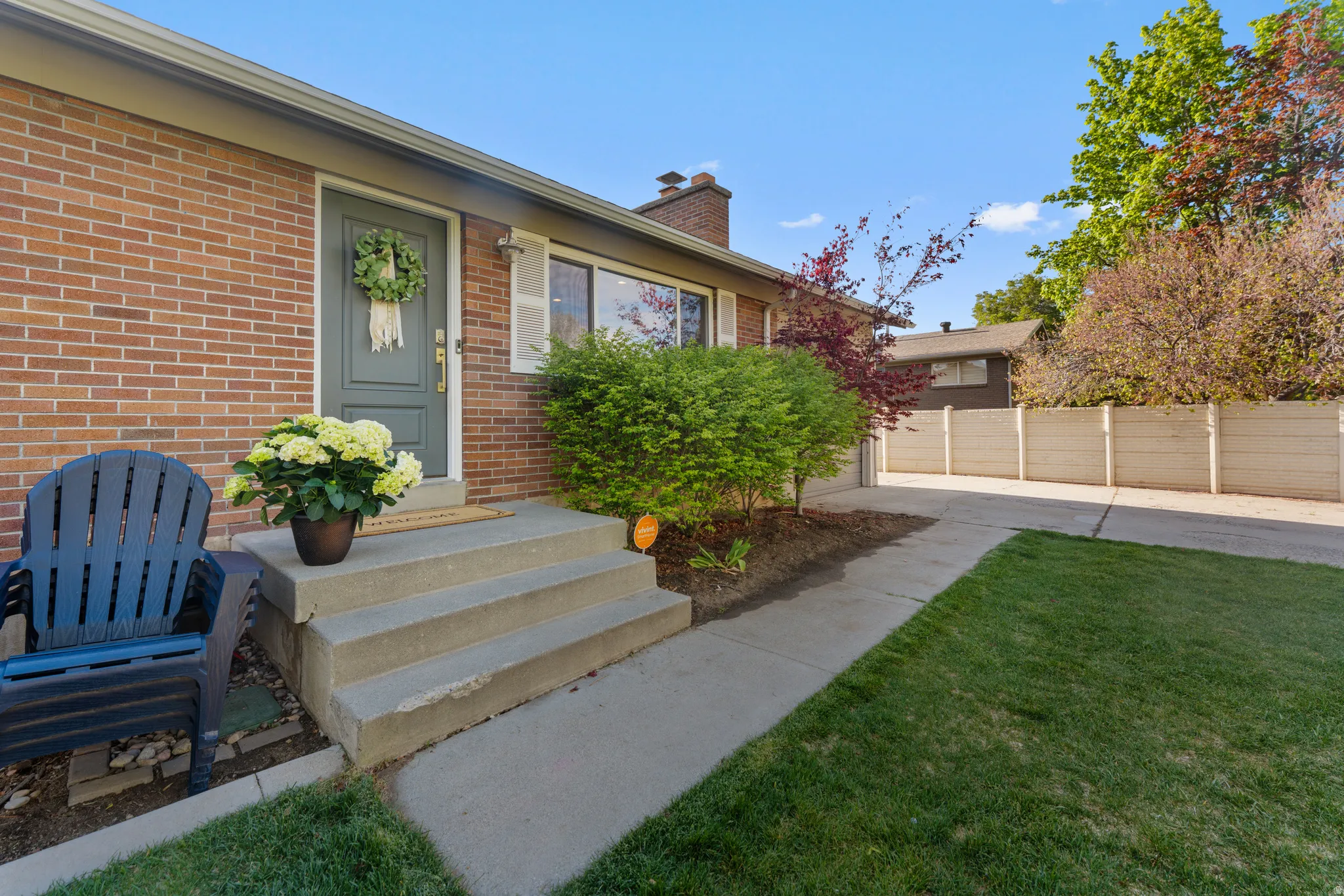 Doorway to property featuring brick siding and a chimney