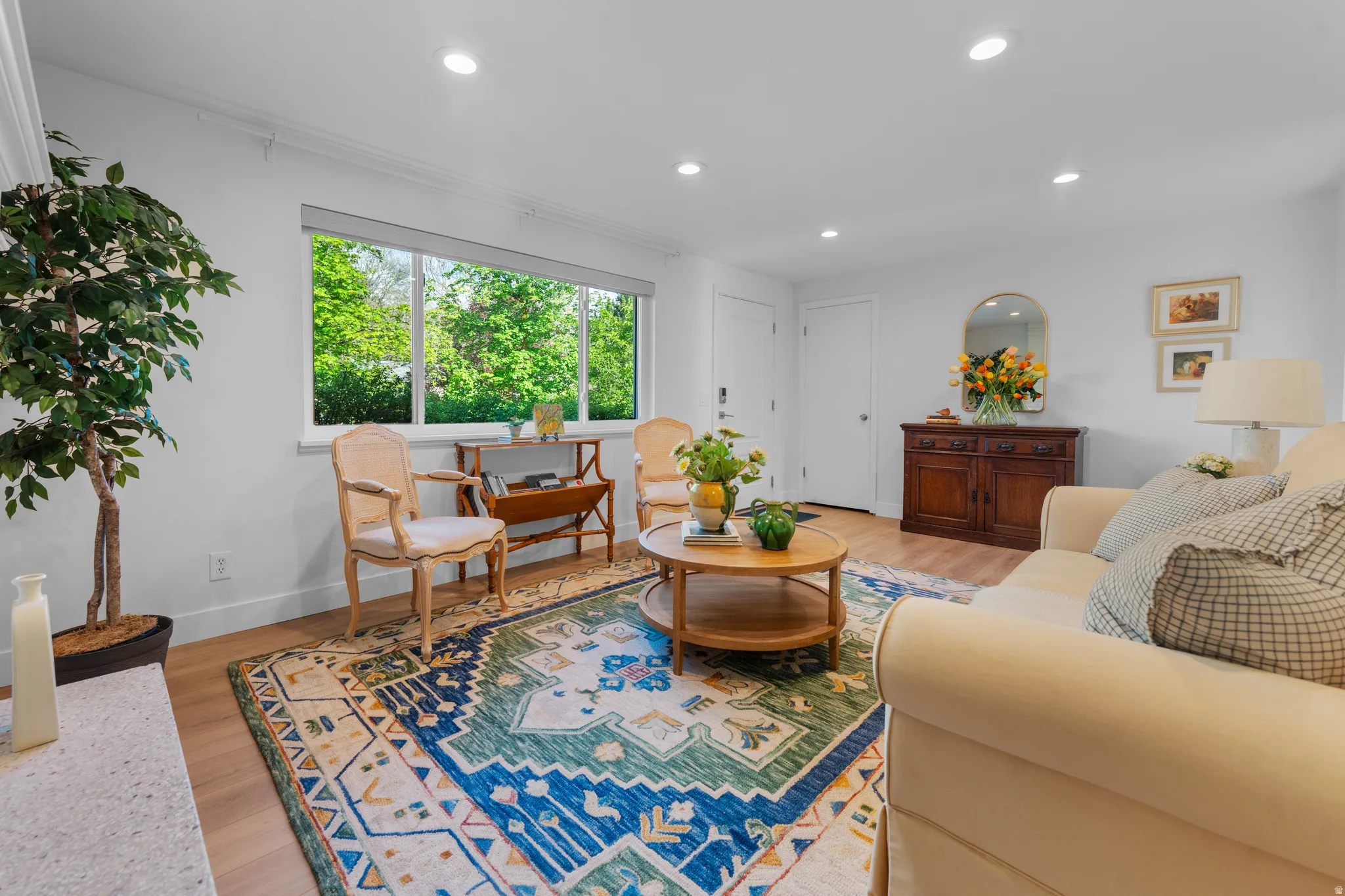 Living room featuring light wood finished floors and recessed lighting