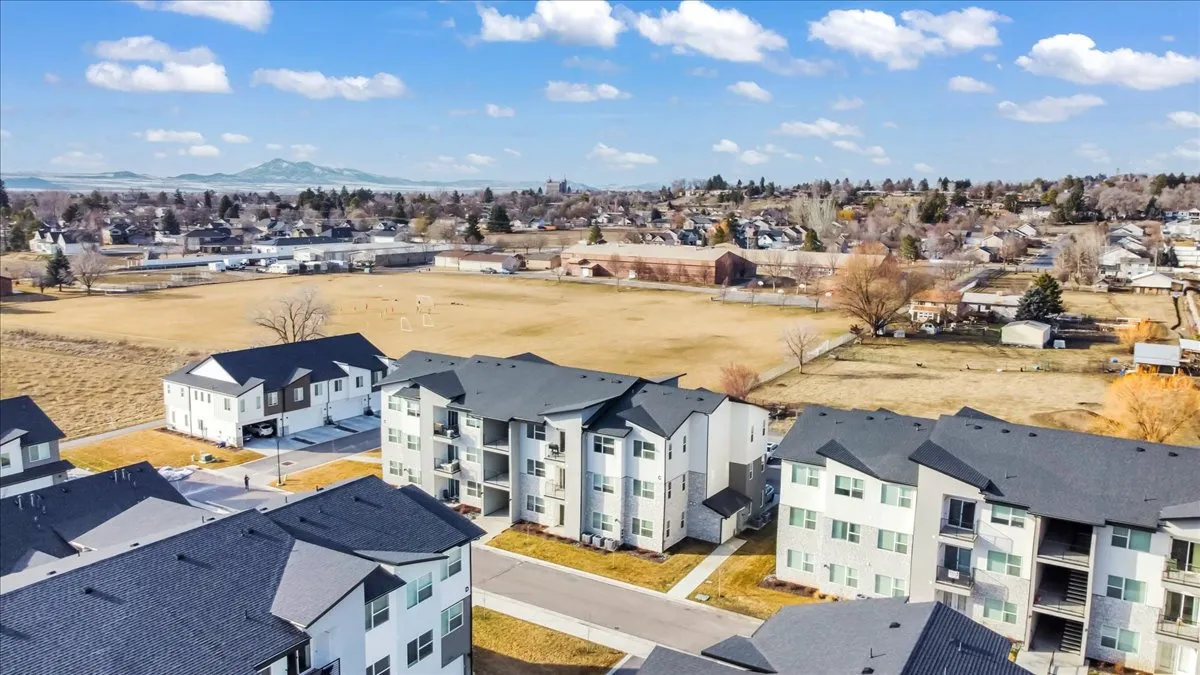 Aerial view of residential area featuring a mountainous background