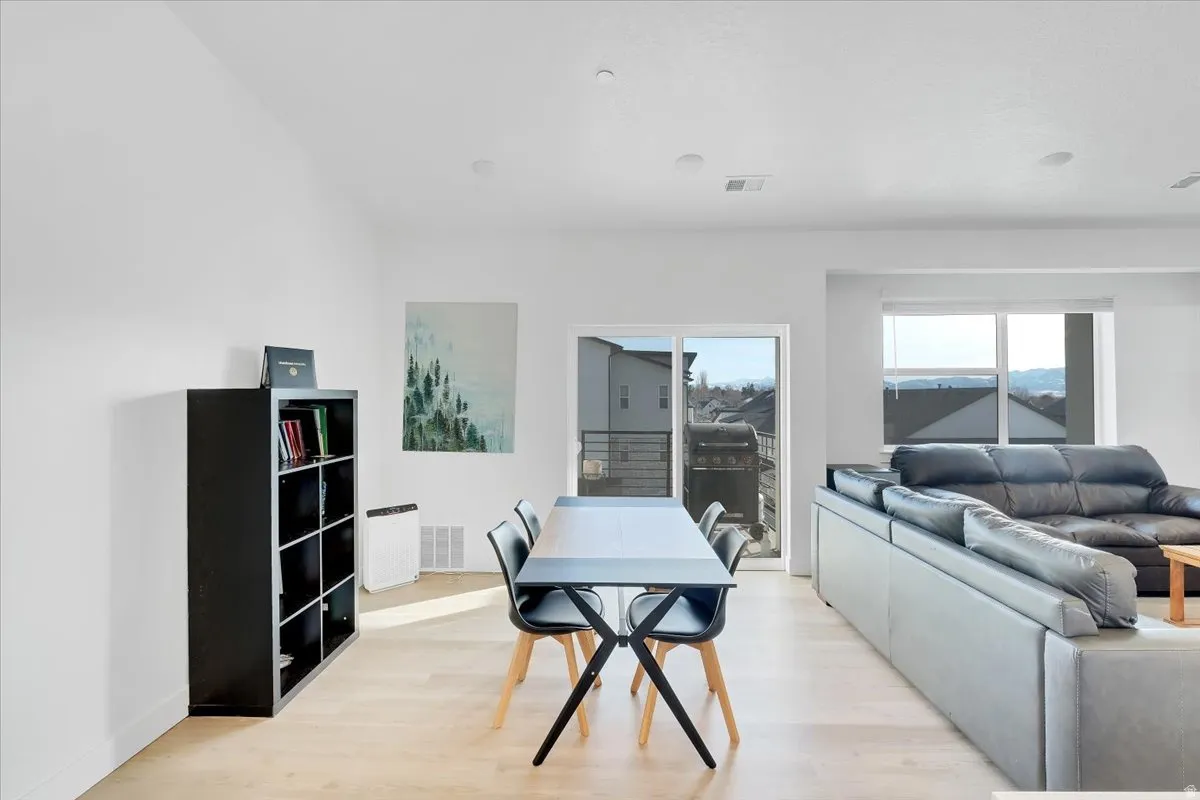 Dining space with light wood-style flooring and baseboards