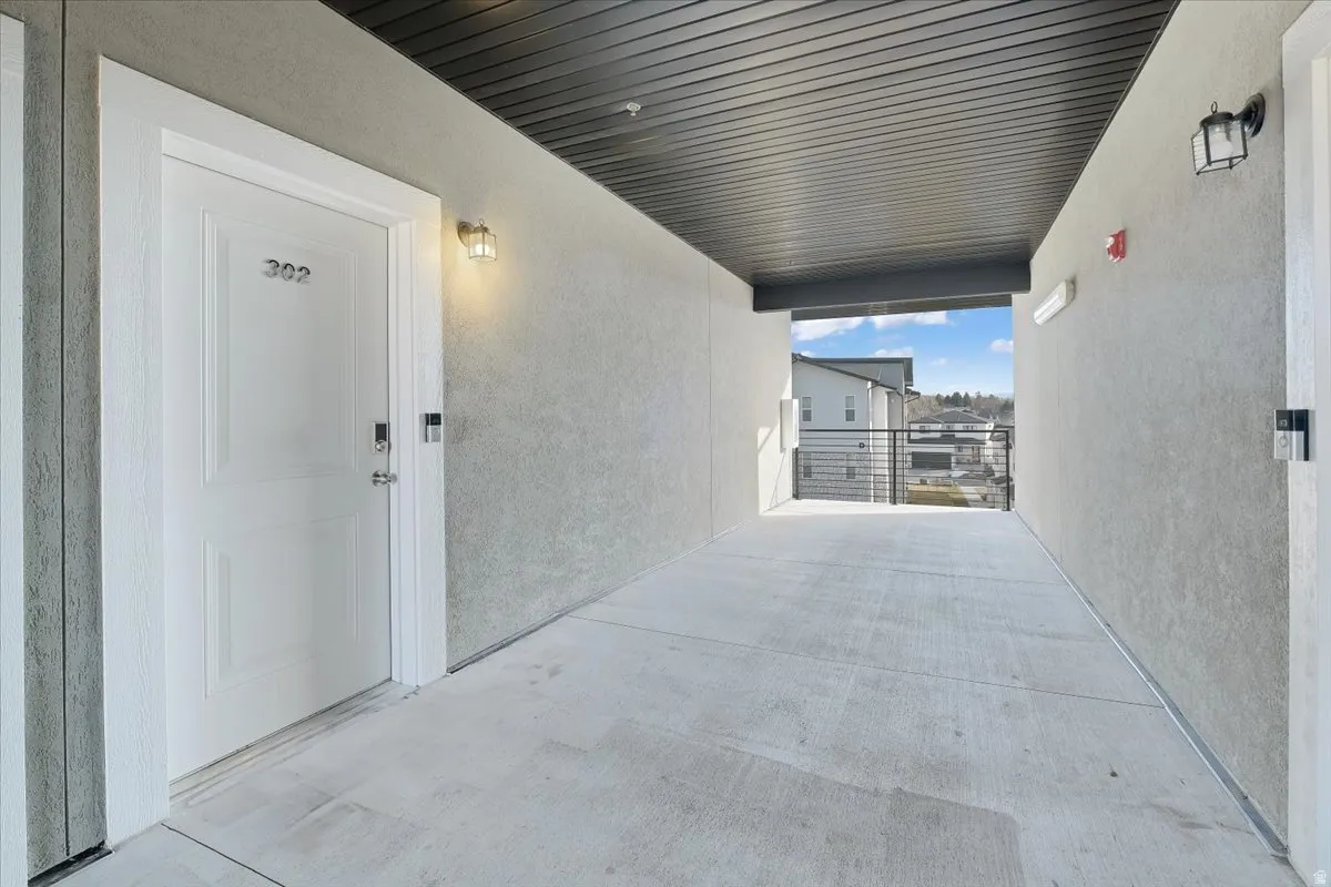 Doorway to property featuring stucco siding