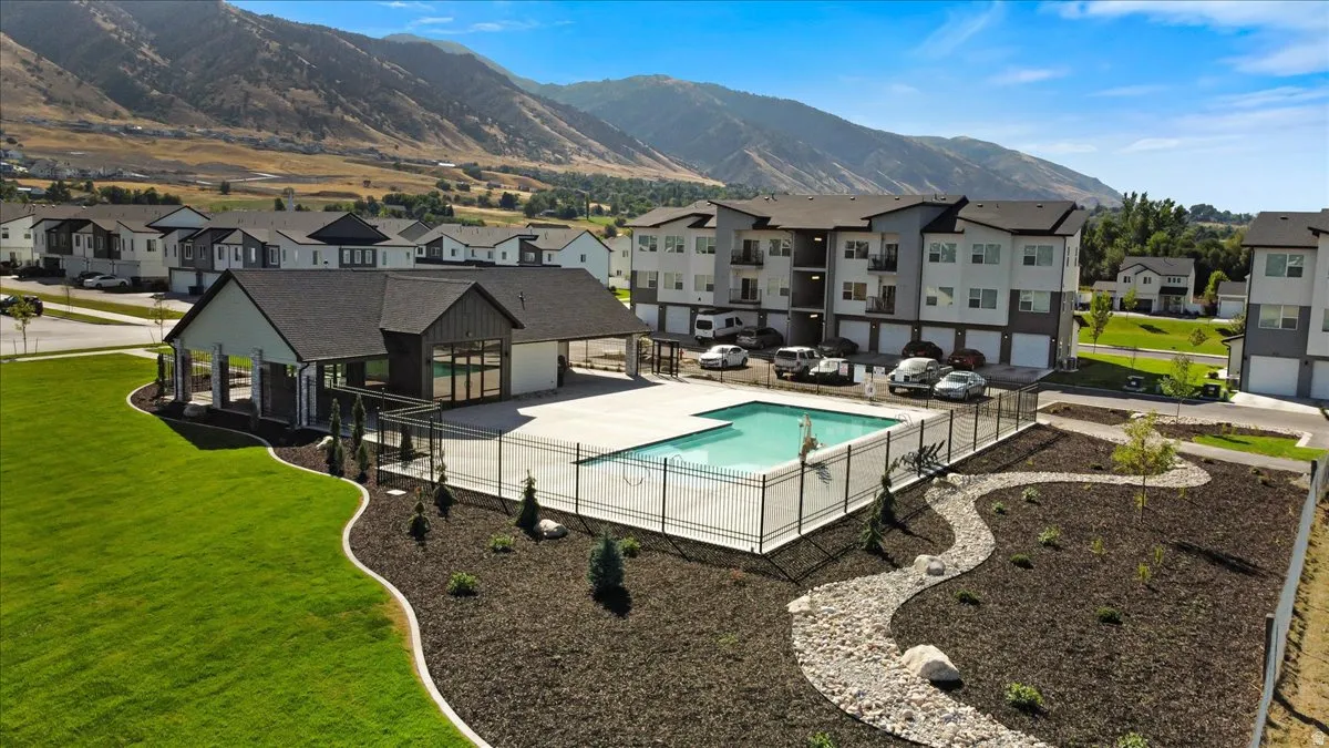 Community pool featuring a residential view, a patio, and a mountain view