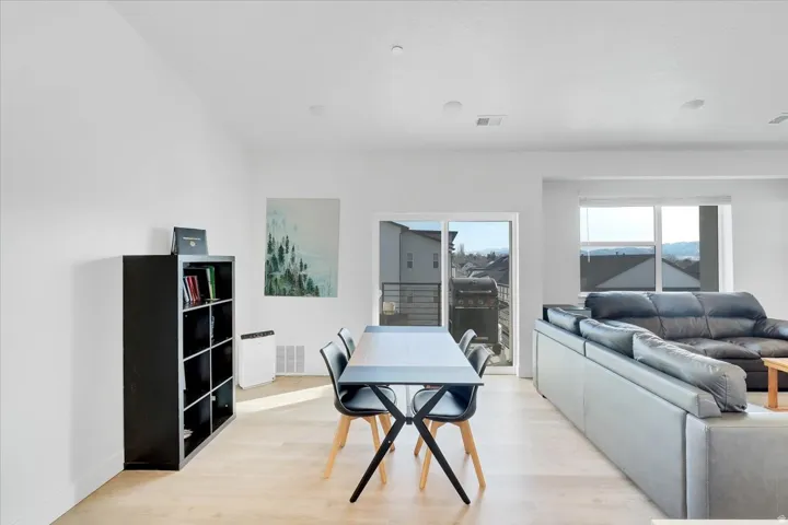Dining space with light wood-style flooring and baseboards