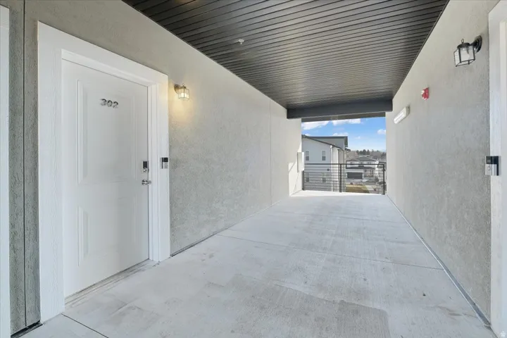 Doorway to property featuring stucco siding