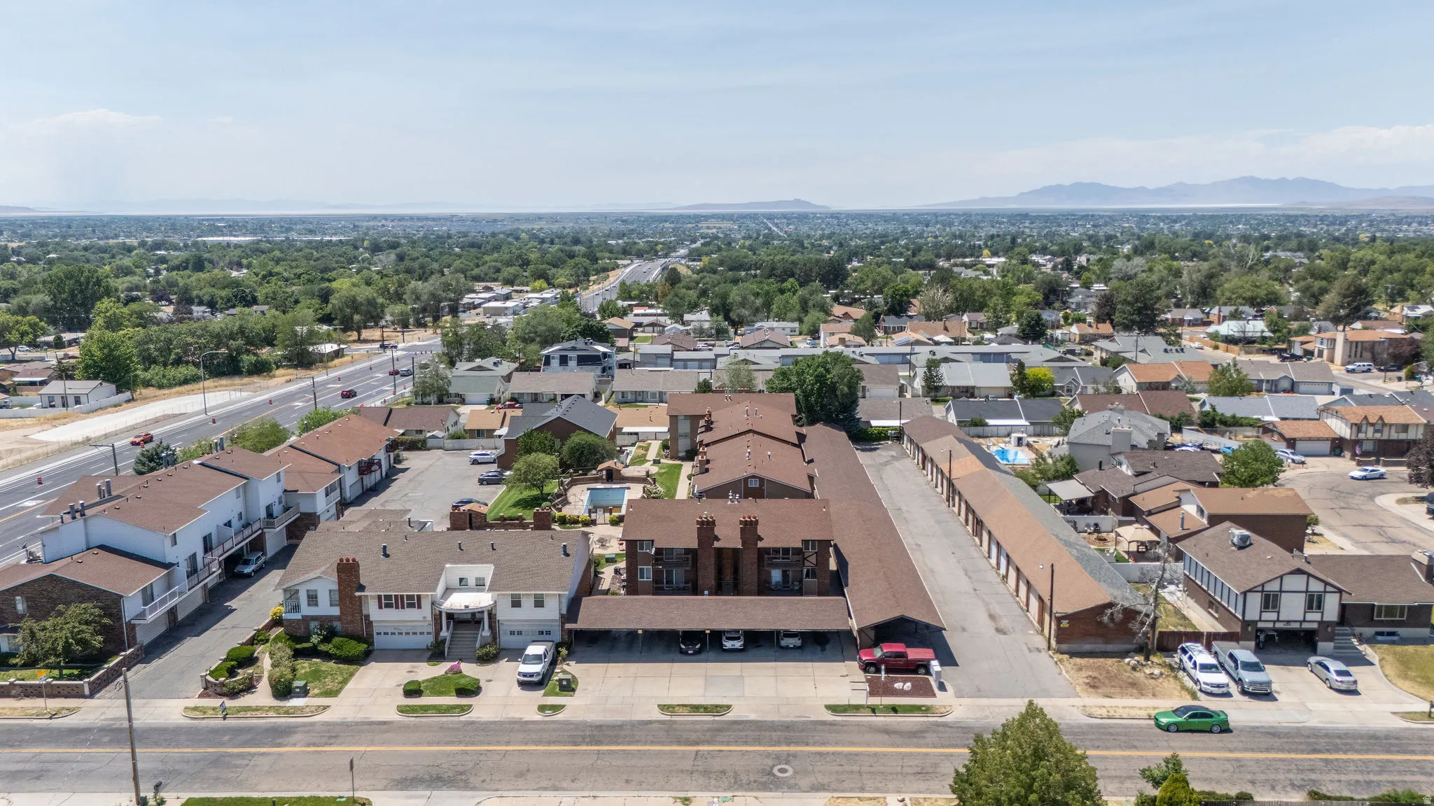 Expansive property featuring multiple residential structures and a long row of storage units