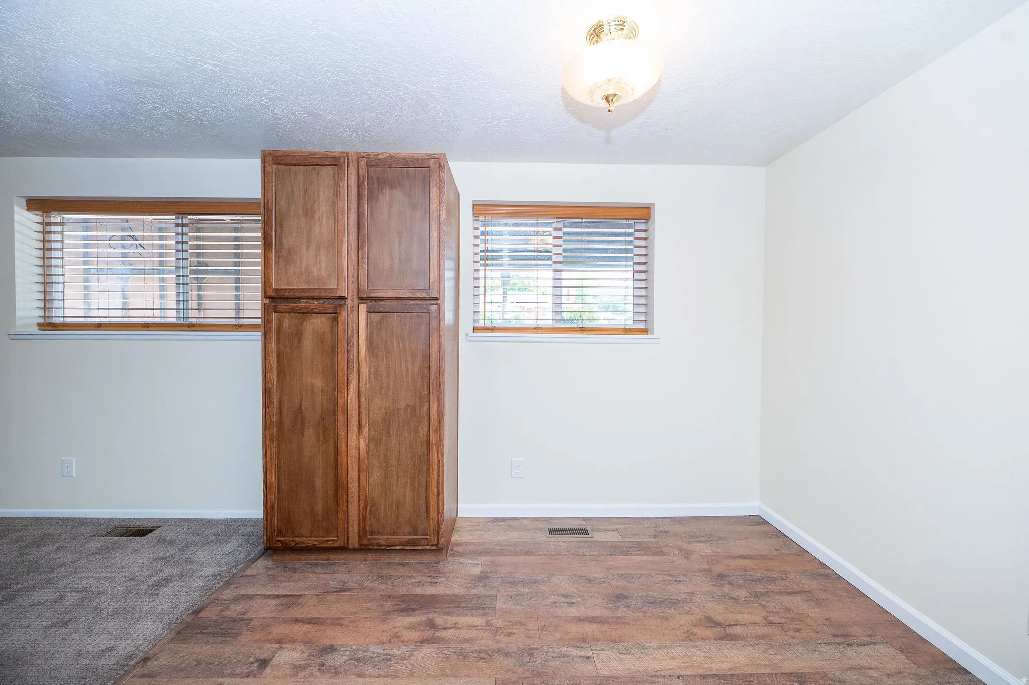 Built-in wood-finish cabinetry providing storage, complemented by warm wood-finish flooring