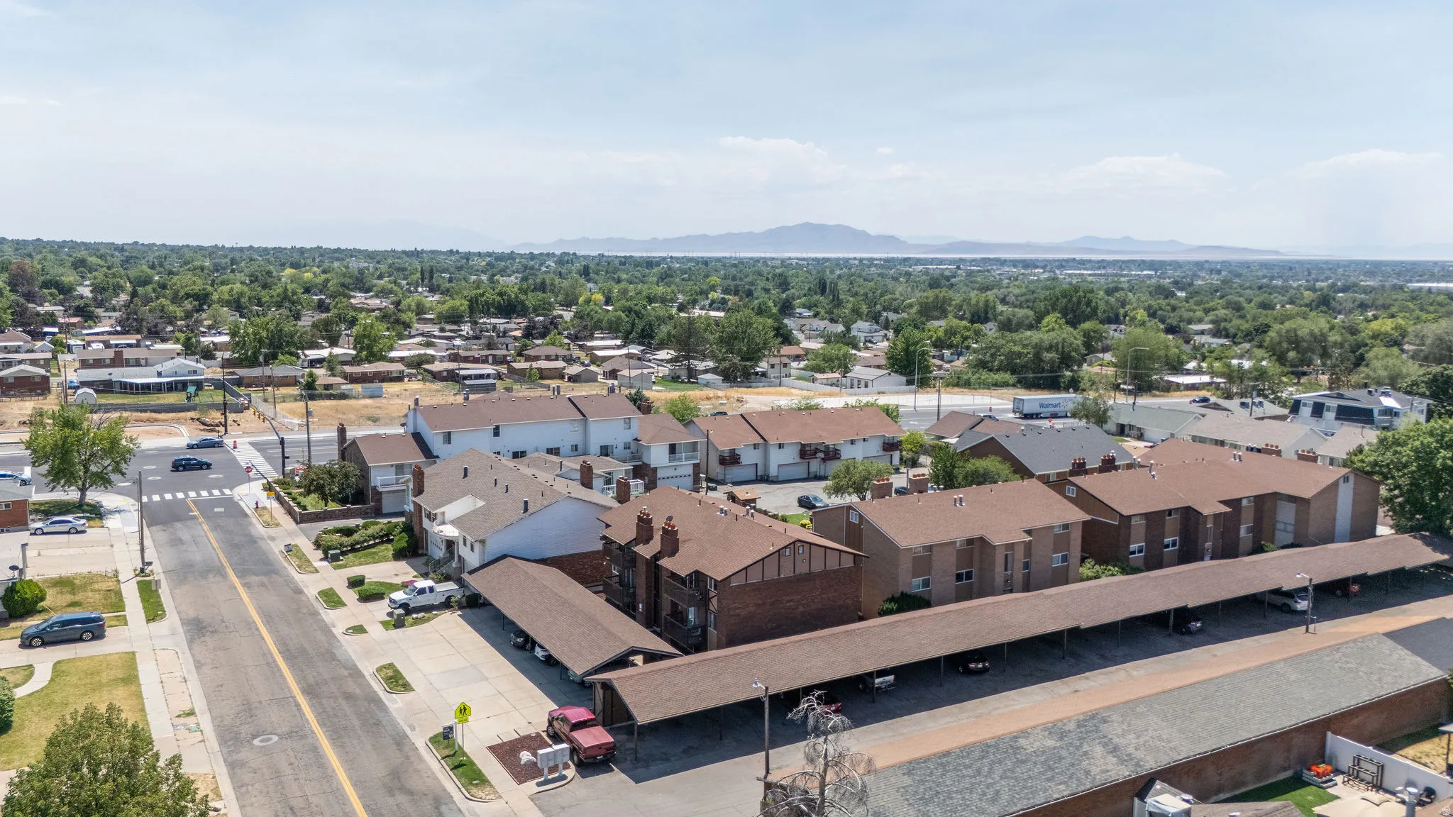 Aerial perspective showcasing a residential neighborhood with a mix of multi-unit buildings and single-family homes