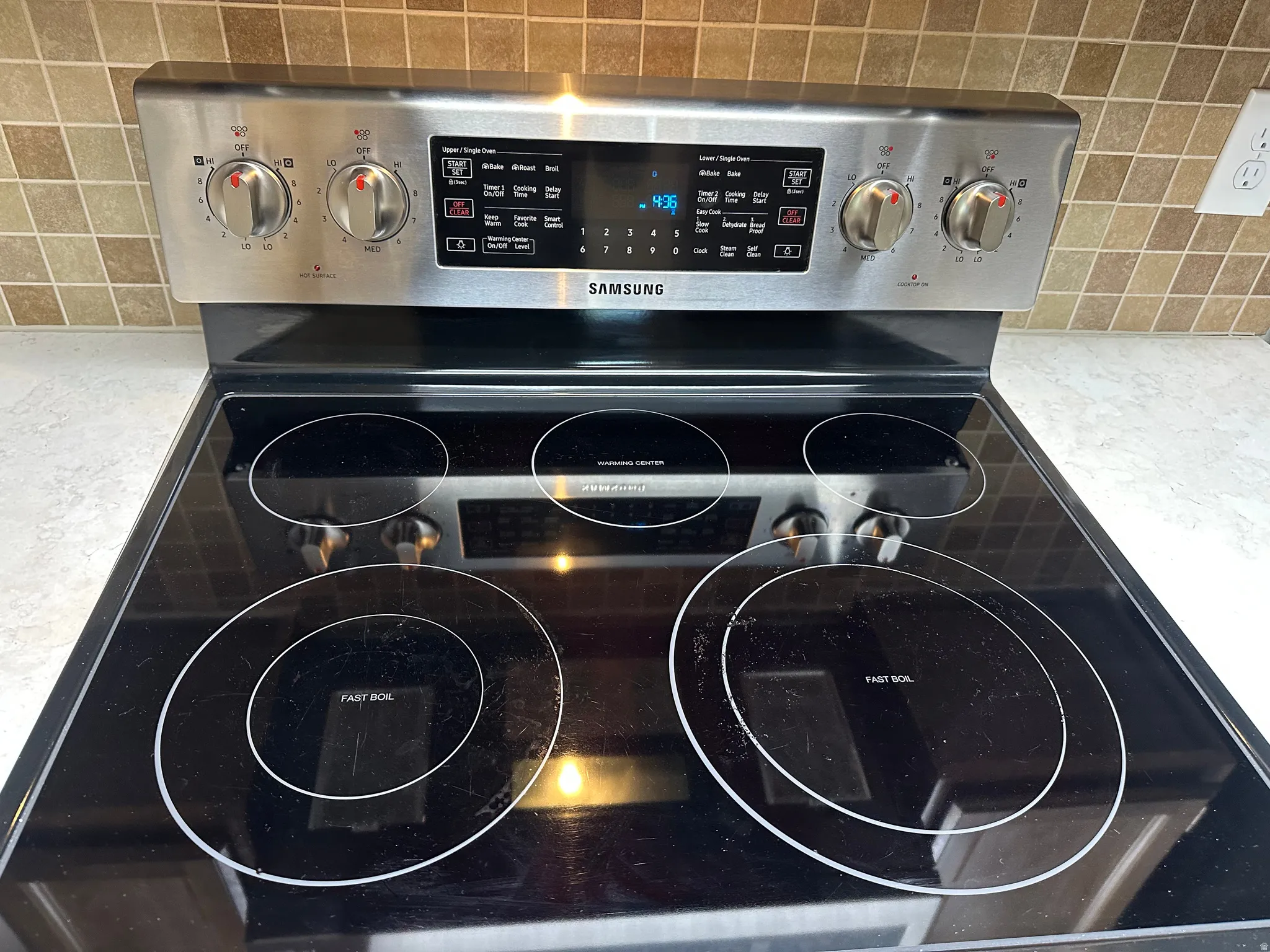 Kitchen view of tasteful backsplash and electric stove