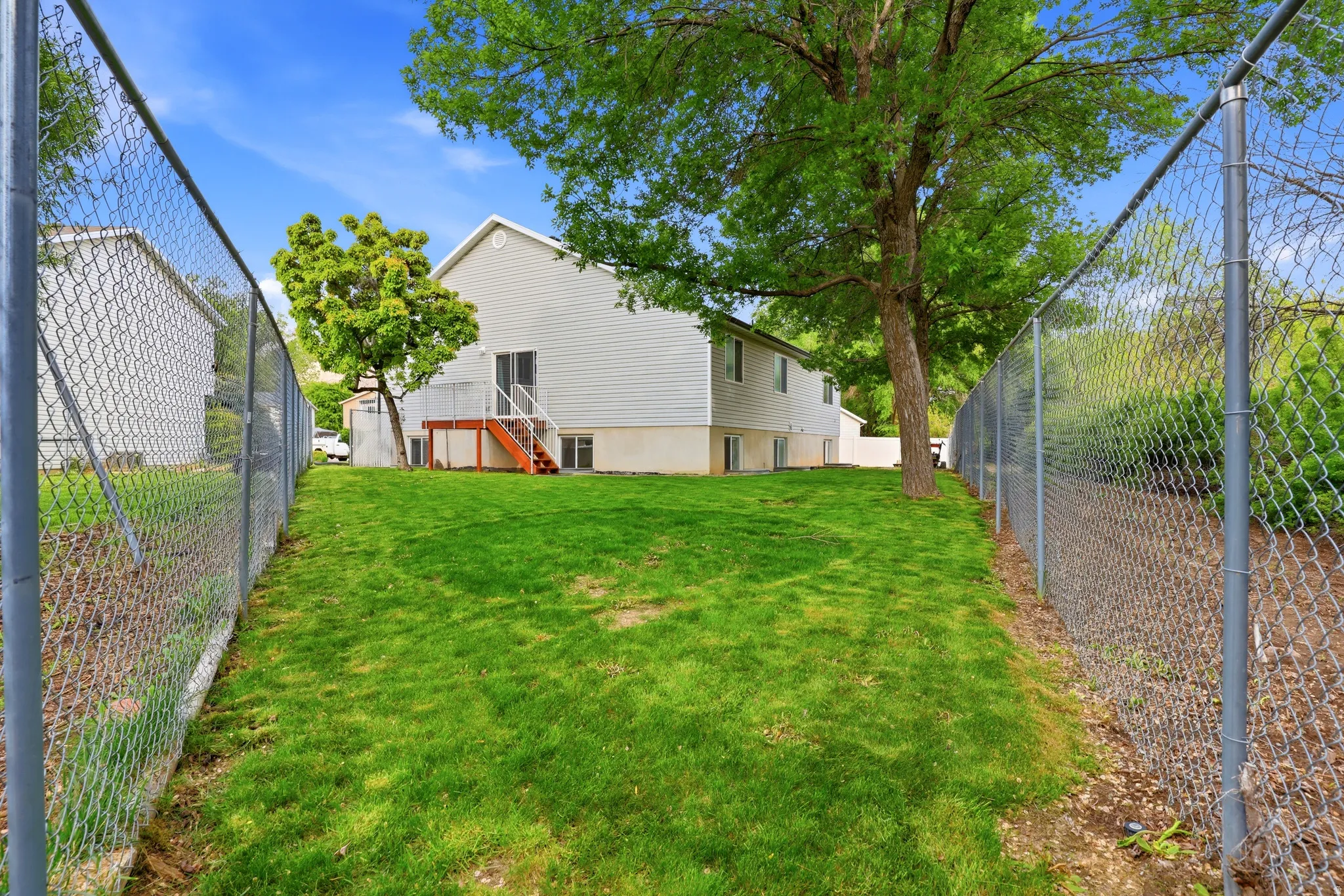 Fenced backyard featuring stairs