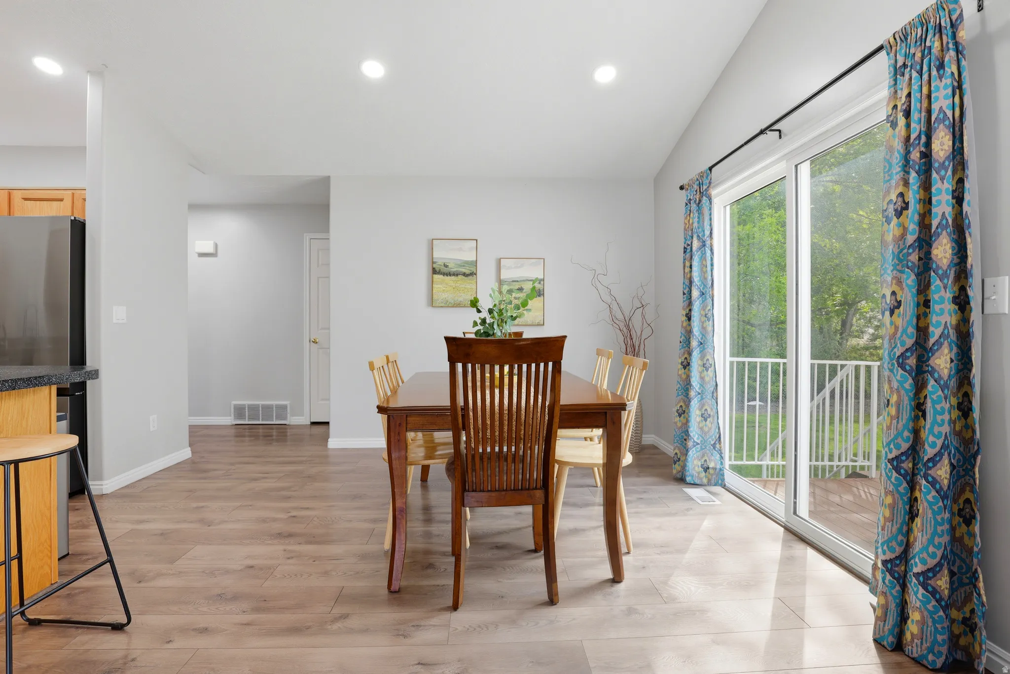 Dining area with light wood-type flooring, recessed lighting, and vaulted ceiling